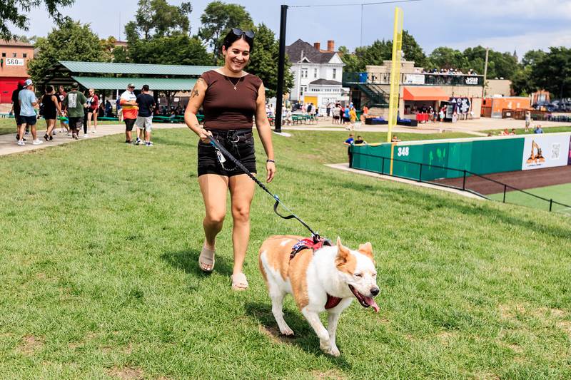 Plainfield resident Syra Sada and Ginger enjoy exploring the grounds during the Joliet Slammers Dog Day event, presented by University of St. Francis, on Aug. 10, 2025.