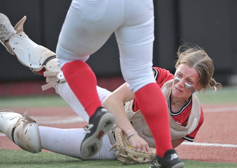 Huntley catcher Madison Rozanski falls with the ball after diving to make the last out of the fifth inning against Mundelein in the IHSA Class 4A softball supersectional game at The Ballpark at Rosemont on Monday, June 3, 2024.