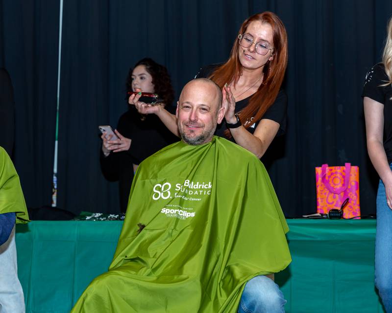 Josh Thomas head is shaved at the St Baldricks Foundation event for Gwen Cola at Forest Road Elementary School in La Grange Park. March 23, 2023.