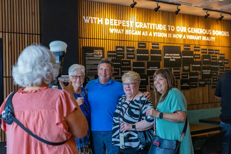 Photographer Jennifer Heredia photographs attendees of the Spring Valley Community Center grand opening on August 7, 2025 in Spring Valley.
