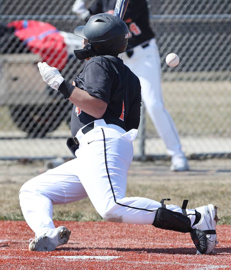 DeKalb’s Maddux Clarence is hit by a pitch during their game against Dixon Tuesday, March 28, 2023, at DeKalb High School.