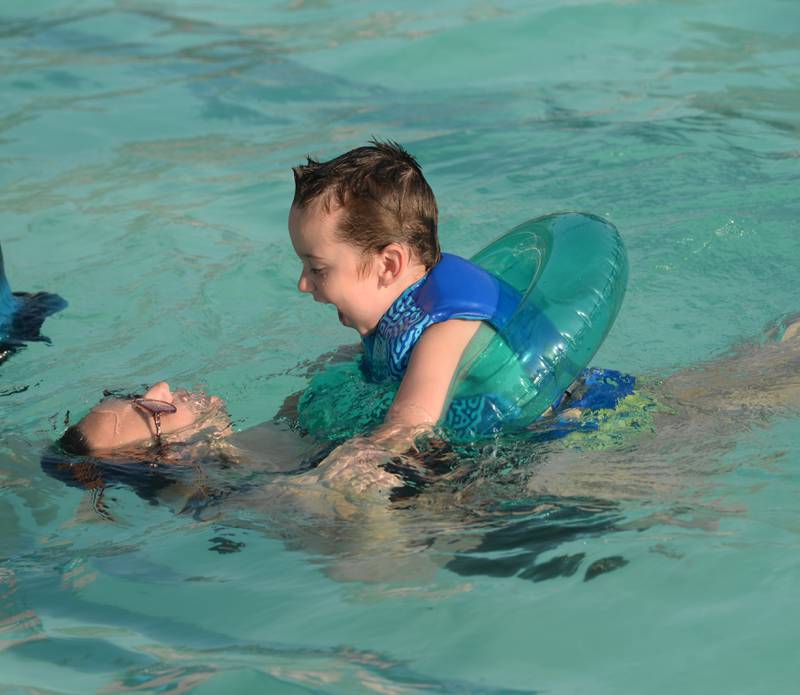 Kalen Spengler of Polo swims with her son, Oliver, 3, at the Polo Pool on Thursday, Aug. 24, 2023. The pool was open from 5-8 p.m. during the recent hot spell to give people a place to cool down.