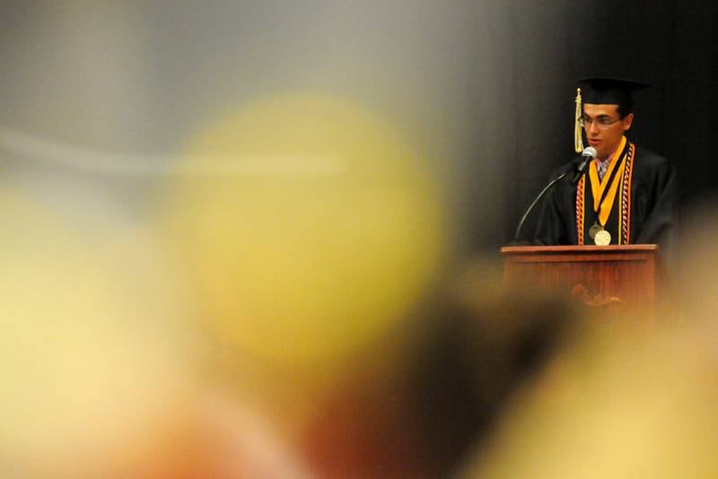 Valedictorian Steven Austin address the graduating class Sunday, May 22, 2022, during the Harvard High School Commencement Ceremony in Harvard .