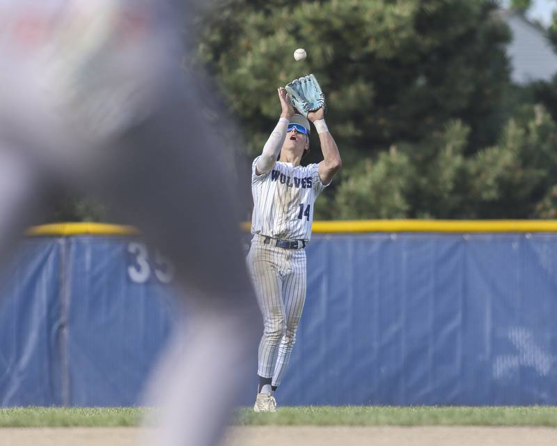 Oswego East's Dominic Battista (14) makes a catch in the outfield while the batter runs to first during baseball game between Oswego East at Oswego. Monday, May 19, 2025 in Oswego.