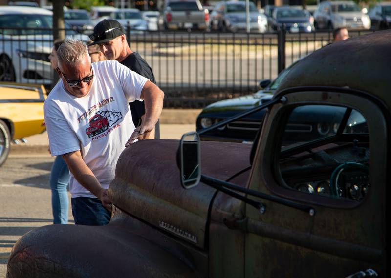 Jim Devitt of Downers Grove closes the hood of his truck during the Moose Cruise Night at the Moose Lodge  in Downers Grove on Friday, June 3, 2023.