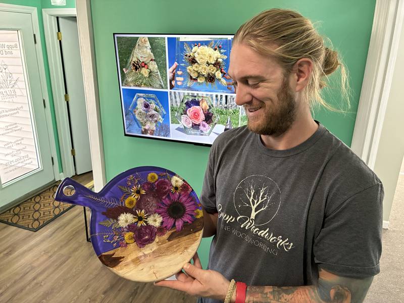 Trevor Bupp makes the wooden portions of the Bupp Woodworks & Designs. They've had a workshop in McHenry for two years, giving them space to meet with clients and Tina Bupp a space to dry and preserve the flowers.