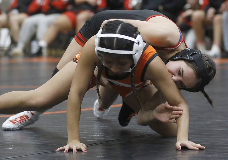 Huntley’s Taylor Casey controls McHenry’s Alexa Garcia during the 110-pound match of a Fox Valley Conference girls wrestling match Thursday, Jan. 11, 2024, at McHenry High School.