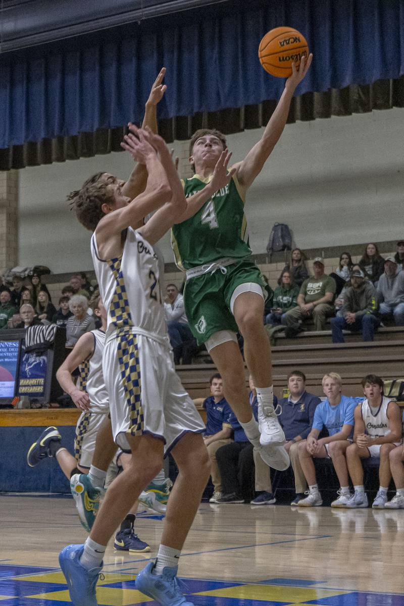 St. Bede's Geno Ferrari drives to the basket against Marquette's Lucas Craig during the game on January 10, 2025 at Marquette Academy.