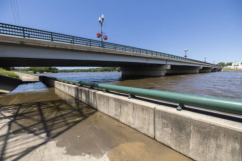 High waters spill onto the walkway under the Peoria bridge Wednesday, June 26, 2024 in Dixon. Recent storms are thought to be the cause of the damage to the downtown dock.