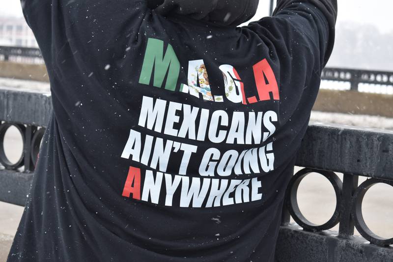 A protester's T-shirt reads "MAGA: Mexicans Ain't Going Anywhere" during a protest Saturday, Feb. 15,  2025, on the First Avenue bridge between Sterling and Rock Falls.