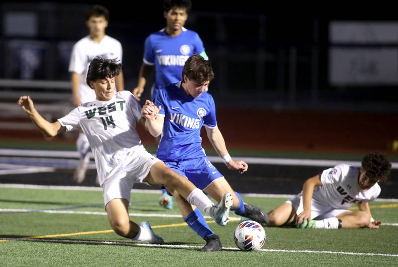 Glenbard West’s Angel Garnica (left) and Geneva’s Jackson Raby battle for the ball during the Class 3A St. Charles North Sectional semifinal on Tuesday, Oct. 29, 2024 in St. Charles.