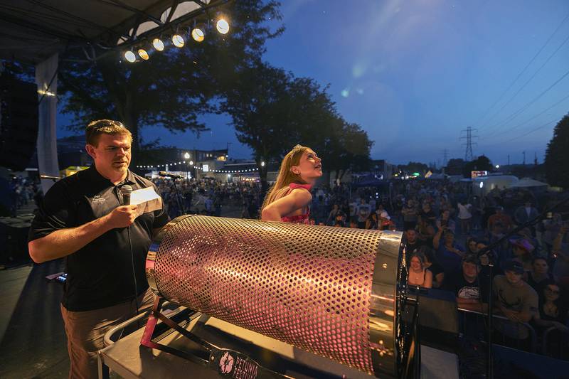 Petunia queen Teyla Wendt draws out the winner of the Petunia Fest 50/50 winner Monday, July 3, 2023 before the Everclear show in Dixon.