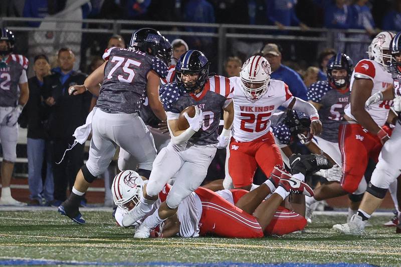 Lincoln-Way East’s Brody Gish sheds a tackle on a run against Homewood-Flossmoor on Friday, Sept. 27, 2024 in Frankfort.