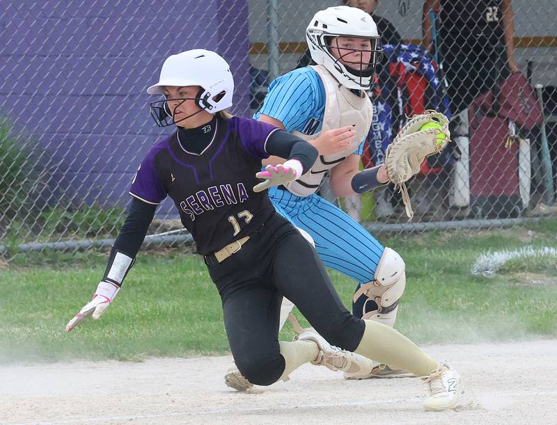 Serena's Brynley Glade scores the teams first run as Marquette catcher Kelsey Cuchra misses the tag at the plate during the Class 1A Regional title game on Friday, May 22, 2026 at Serena High School.