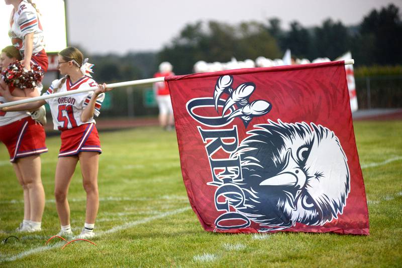 Oregon cheerleaders hold flags as the Hawks take the field against  Rock Falls for their 2025 Homecoming game on Friday, Sept. 19, 2025 at Landers-Loomis Field in Oregon.