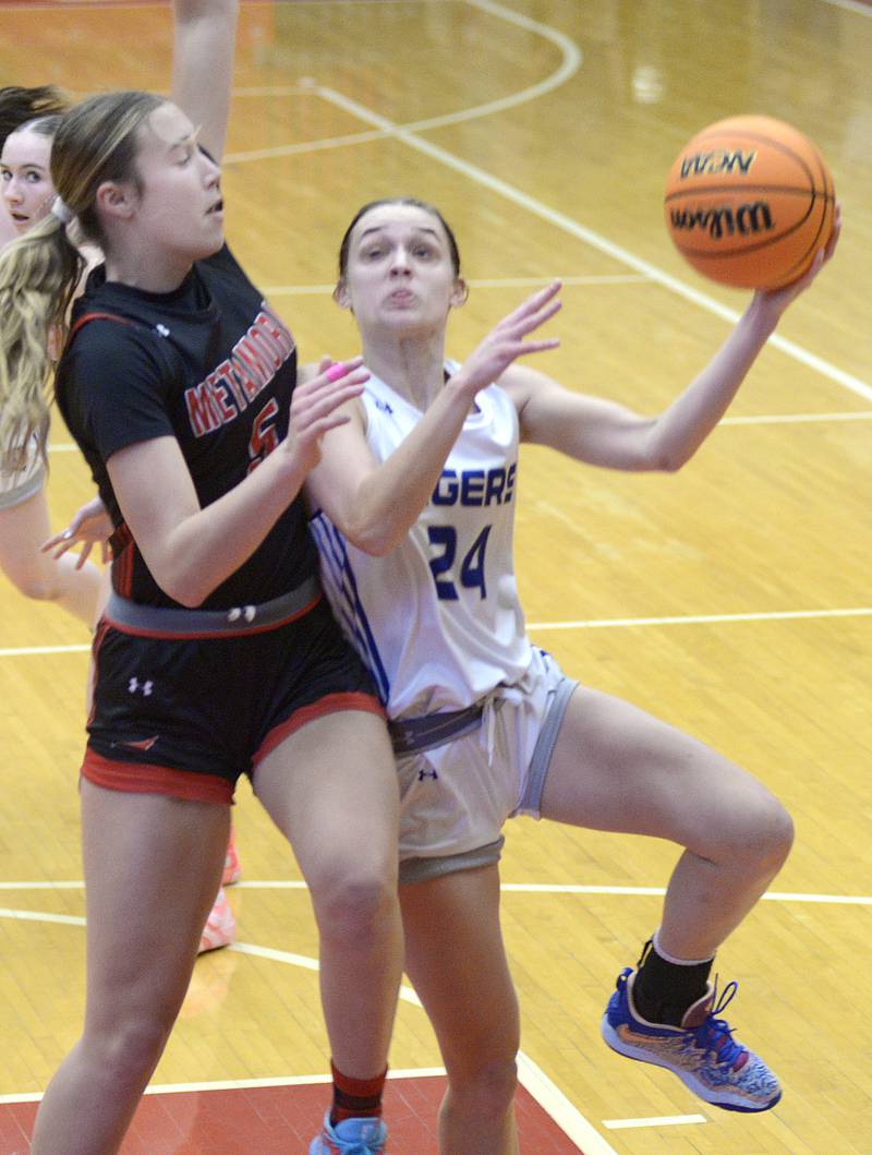 Princeton’s Keighley Davis tries to go up and around Metamora’s Baylie Nena  to the basket in the 1st period Tuesday at the Ottawa Holiday Tournament.