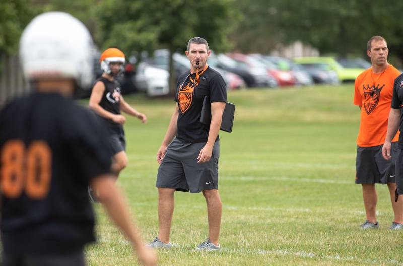 St. Charles East Coach Nolan Possley blows the whistle during practice at St. Charles East on Monday, Aug. 8, 2022.