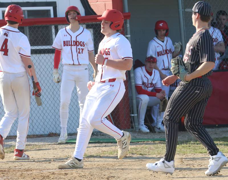 Streator's Cole Winterrowd scores a run as Hall pitcher Jaxon Pinter (right) covers the plate on Thursday, March 19, 2026 at Streator High School.