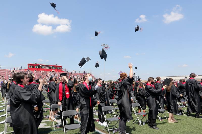 Huntley High School graduates toss their caps up into the air at the end of their graduation ceremony Saturday, May 22, 2021, at the school in Huntley.  The school graduated 736 students over three Saturday ceremonies.