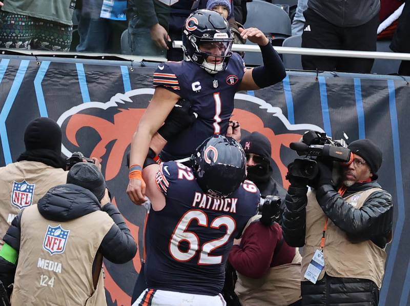 Chicago Bears quarterback Justin Fields gets a lift from Chicago Bears guard Lucas Patrick after scoring a touchdown during their game Sunday, Dec. 10, 2023 at Soldier Field in Chicago.