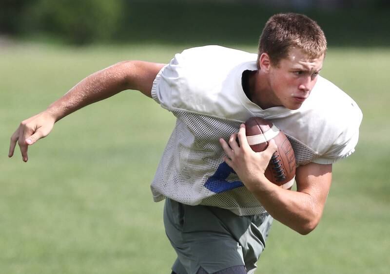Genoa-Kingston’s Brady Brewick runs the ball during practice Friday, Aug. 11, 2023, at the school in Genoa.