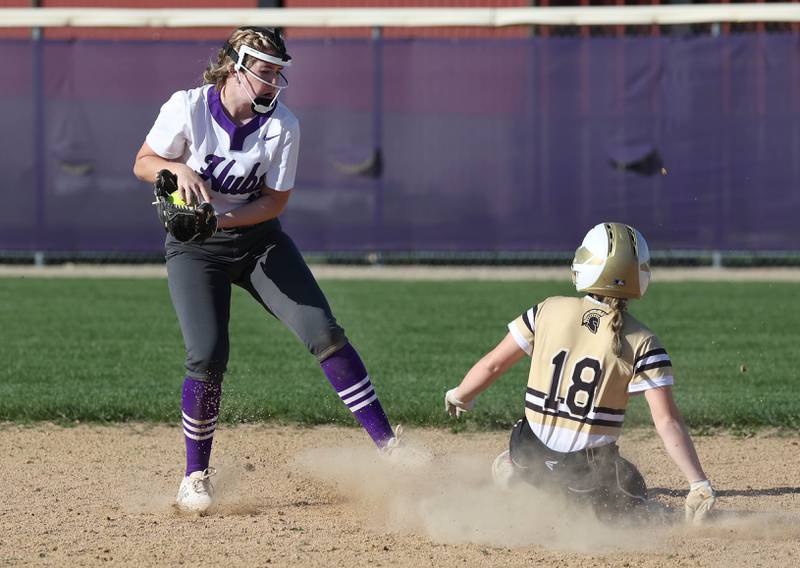 Sycamore's Addison McLaughlin slides in safely at second as Rochelle's Madigan Williams takes the throw Monday, April 15, 2024, during their game against Rochelle at Rochelle High School.