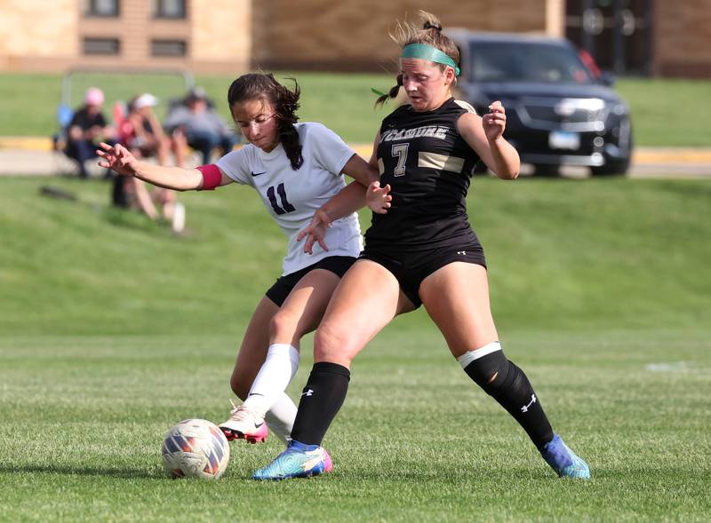 Dixon’s Leah Stees (left) and Sycamore's Anya Berry go after the ball during their game Thursday May 15, 2025, at Sycamore High School.
