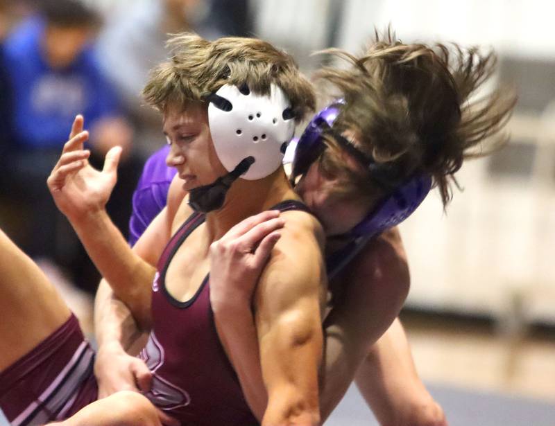 Prairie Ridge’s Tymen Robinson, left, battles Hampshire’s Luthor Rajcevich at 106 pounds in varsity boys wrestling on Thursday, Dec. 4, 2025, at  Prairie Ridge High School in Crystal Lake.