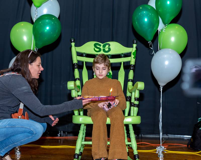 Gwen is presented with birthday cupcakes at the St Baldricks Foundation event for Gwen Cola at Forest Road Elementary School in La Grange Park. March 23, 2023.