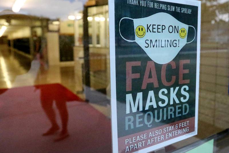 Signs remind staff and students that masks are required for entry at Grant Elementary and Marengo Community Middle Schools on Tuesday, Aug. 25, 2020 in Marengo.