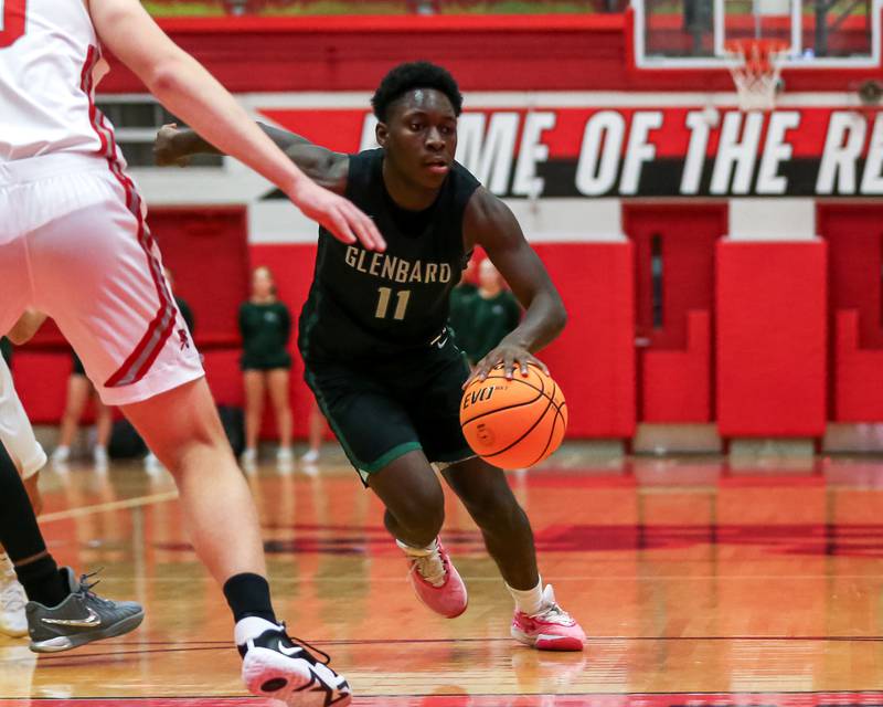 Glenbard West's Teyion Oriental (11) makes a move with the ball during their basketball game between Glenbard West at Hinsdale Central, Friday  Dec 6, 2024  in Hinsdale.