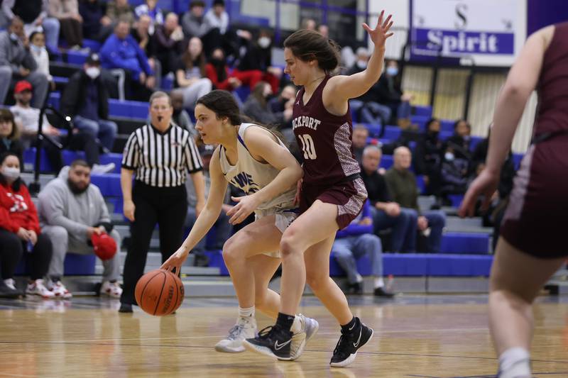 Lincoln-Way East’s Grace Sheehan drives around Charlotte Fahrner of Lockport in the Class 4A Lincoln-Way East Regional semifinal. Monday, Feb. 14, 2022, in Frankfort.