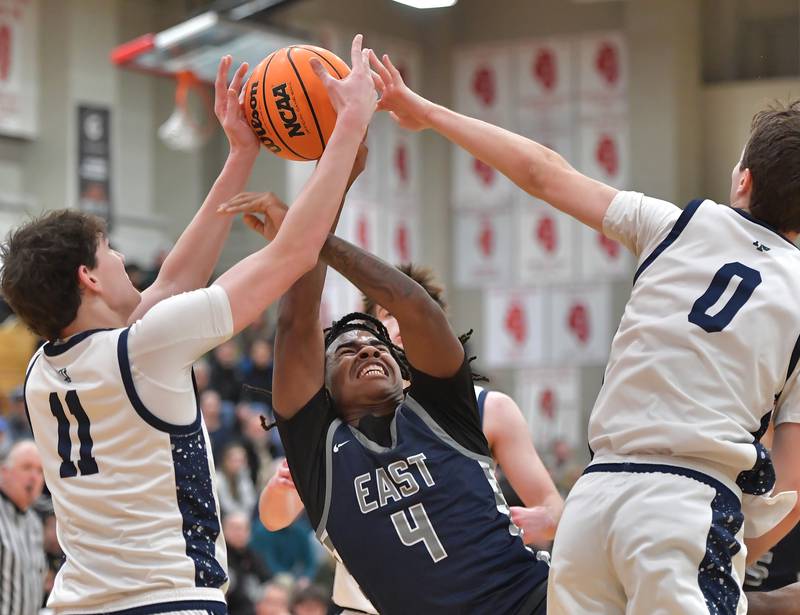 Oswego East’s Rmani Sims (4) goes down after being fouled by New Trier’s Owen Foster (0) during a When Sides Collide Shootout game on January 24, 2026 at Benet Academy in Lisle.