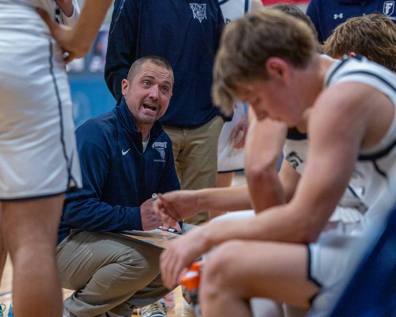Fieldcrest Head Coach Jeremy Hahn talks to team during timeout on Monday, December 15, 2025 at Fieldcrest High School in Minonk.
