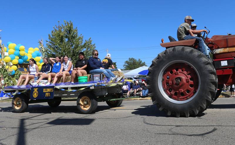 Princeton High School FFA members ride in a hayrack during the 52nd annual Homestead Festival parade on Saturday, Sept. 9, 2023 in Princeton.