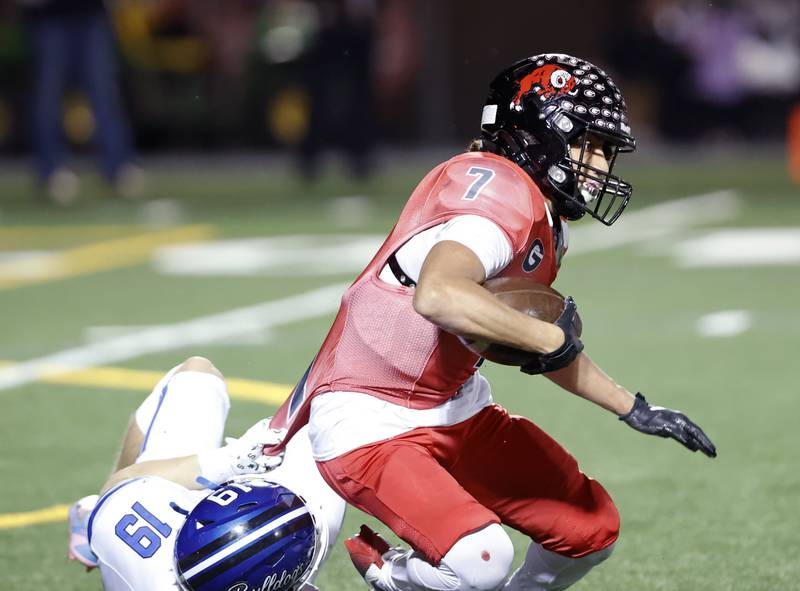 Glenbard East's Mike Orive (7) is stopped by Riverside Brookfield's Timothy Giacomelli Jr. (19) during the varsity football game between Riverside Brookfield and Glenbard East on Friday, Oct. 24, 2025 in Lombard, IL.