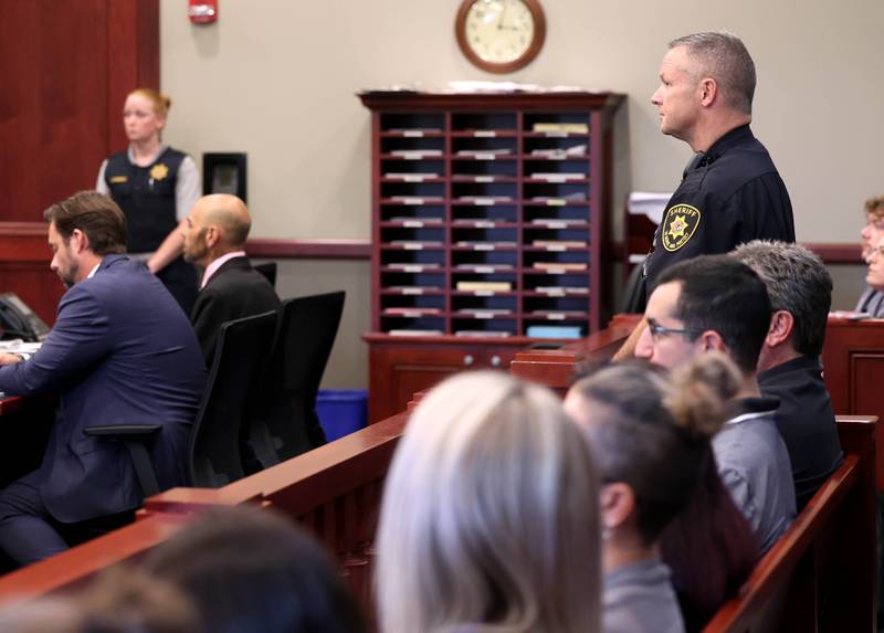 DeKalb County Sheriff Andy Sullivan stands behind Nathan P. Sweeney, 45, of DeKalb, Thursday, June 26, 2025, during the his plea hearing at the DeKalb County Courthouse in Sycamore. Sweeney pleaded guilty Thursday for driving under the influence on March 28, 2024, and causing a crash that killed DeKalb County sheriff‘s deputy Christina Musil.