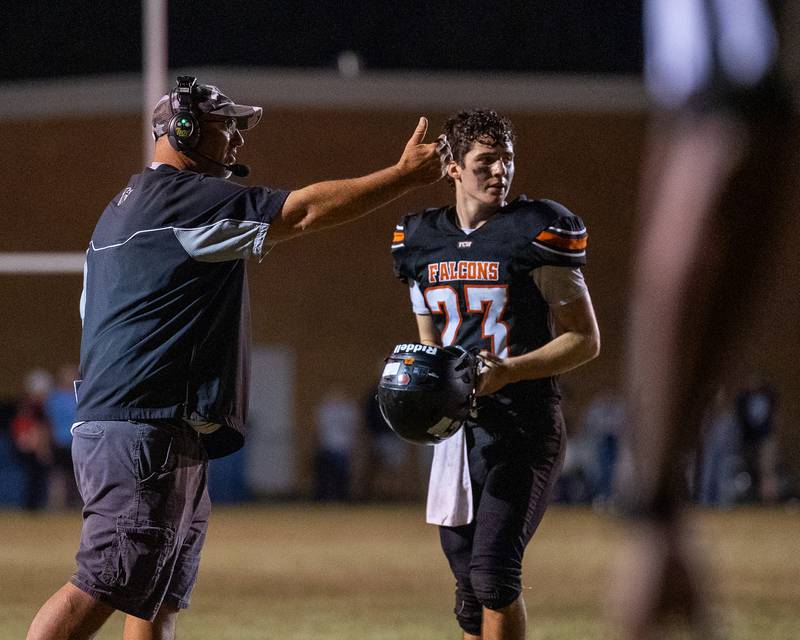 FCW Head Coach, Todd Reed waves to players as Brezdyn Simons (23) watches on Friday, Sept. 26, 2025 at Woodland High School in Streator.