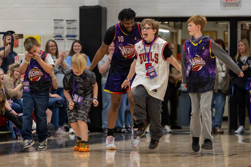 Deven “Just Do It” Dorsett (10) of the Harlem Wizards performs “Griddy” dance with posse of fans on Wednesday, April 16, 2025 at Woodland High School in Streator.