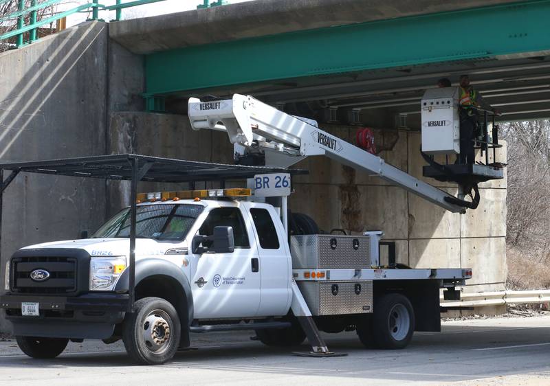 Illinois Department of Transportation crews inspect the 7th Street bridge over Illinois Route 251 after a semi struck it on Monday, March 10, 2025 in Peru. The semi was hauling two clamshell buckets for excavating equipment.