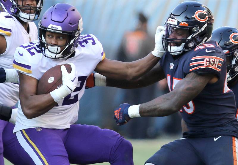 Minnesota Vikings running back Ty Chandler stiff arms Chicago Bears linebacker Joe Thomas Sunday, Jan. 8, 2023, during their game at Soldier Field in Chicago.