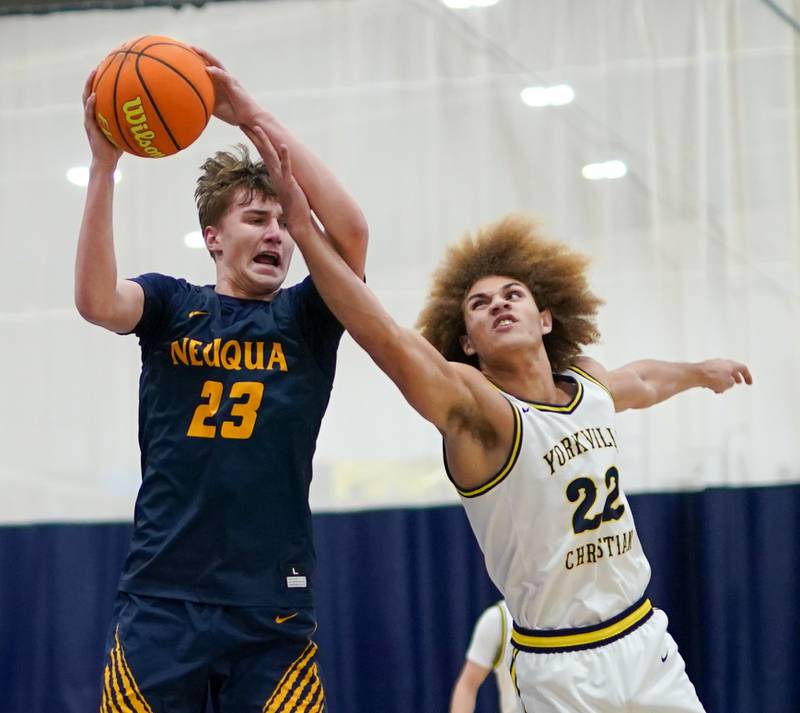 Neuqua Valley's Cole Kelly (23) rebounds the ball against Yorkville Christian's Noah Aguado (22) during a basketball game at Yorkville Christian High School on Tuesday, February 4, 2025.