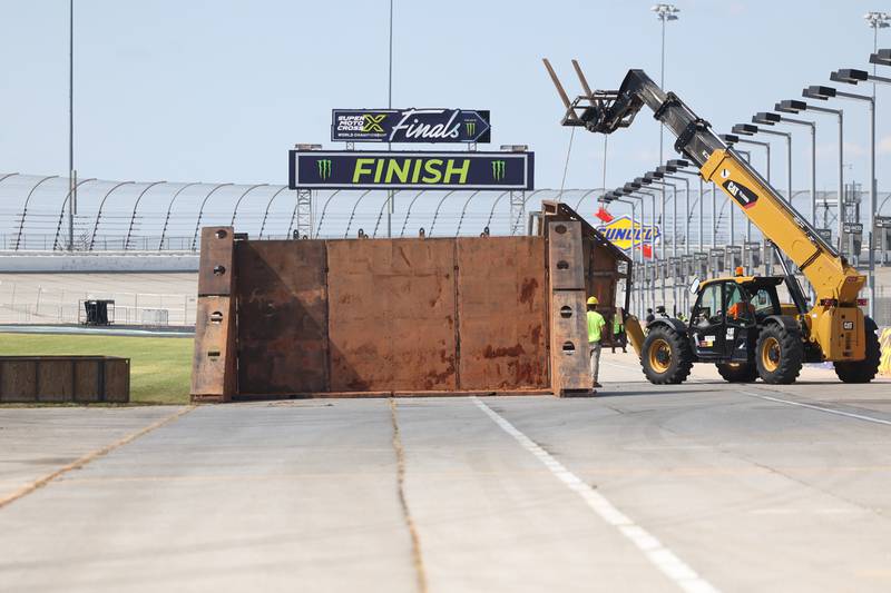 Crews build the foundation for one of the jumps at the finish line on Tuesday for Saturday’s SuperMotocross World Championship Finals at the Chicagoland Speedway in Joliet.