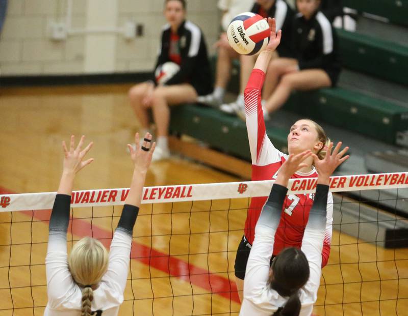 L-P's Aubrey Duttlinger sends a kill past Sycamore's Madilyn Patton and teammate Norah Chami on Tuesday, Sept. 23, 2025 in Sellett Gymnasium at L-P High School.