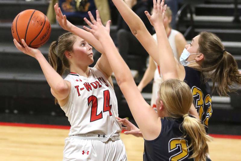 Indian Creek's Audrey Witte shoots over Polo's Natalie Nelson and Lindee Poper during their Class 1A regional game Tuesday, Feb. 15, 2022, at Indian Creek High School in Shabbona.