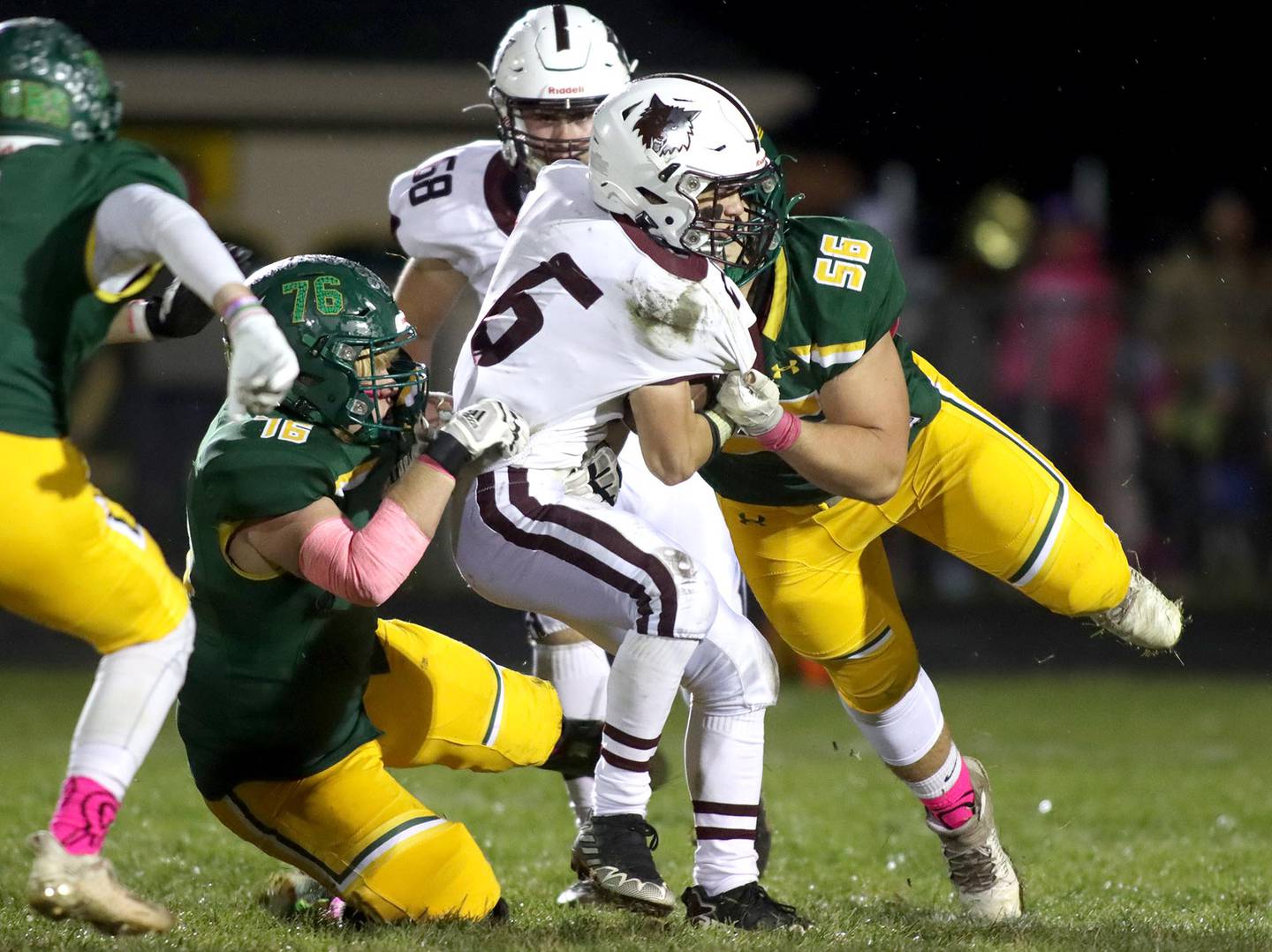 Crystal Lake South’s Nate Compere, left, and Andy Burburija, right, bring down Prairie Ridge’s Luke Vanderwiel in varsity football action at Ken Bruhn Field on the campus of Crystal Lake South Friday evening.