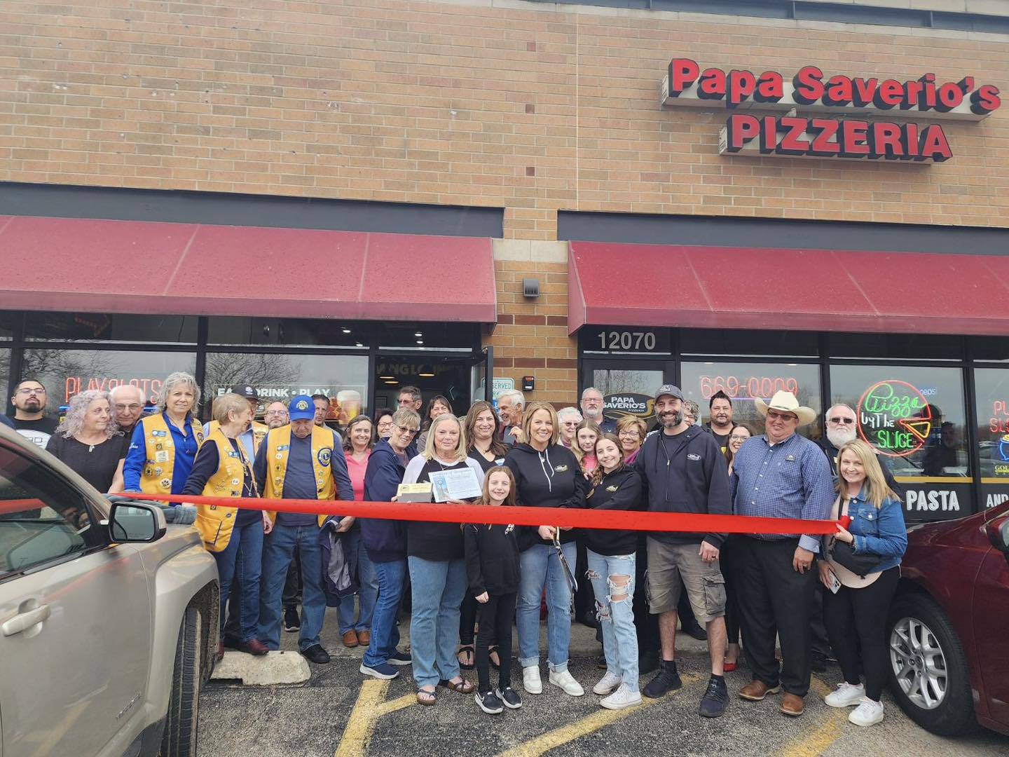 The Huntley Area Chamber of Commerce celebrates a ribbon cutting at Papa Saverio's April 11, 2024.