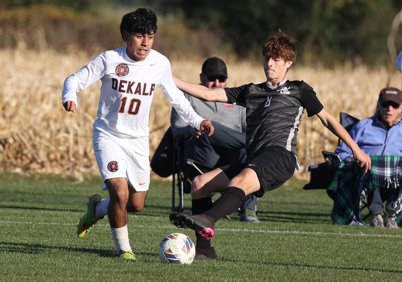 Kaneland's Josh Schimmel tries to kick the ball away from DeKalb's Matais Gutierrez during their game Thursday, Oct. 17, 2024, at Kaneland High School in Maple Park.