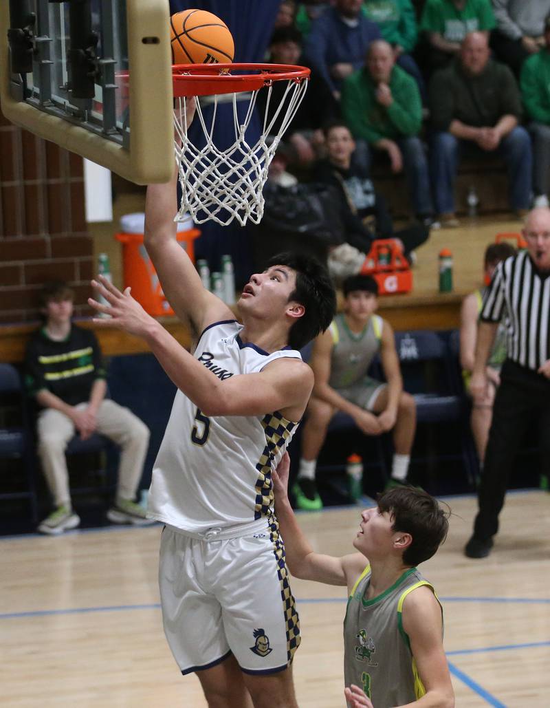 Marquette's Blayden Cassel drives to the hoop as Seneca's James Zydron defends on Friday, Feb. 21, 2025 in Bader Gym at Marquette Academy.