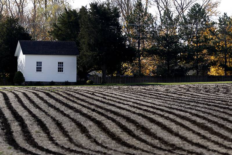 Lines from a freshly harvested field lead to the the Muller Chapel at the intersection of Johnsburg and West Ringwood roads on Wednesday, Oct. 26, 2022. The chapel was built in 1878 by Maria Net Muller in memory of her husband, Peter Muller.